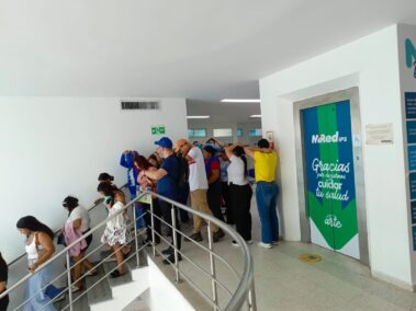Colaboradores y usuarios de MiRed IPS descienden por las escaleras protegiéndose la cabeza durante el Simulacro Nacional de Emergencias 2026.